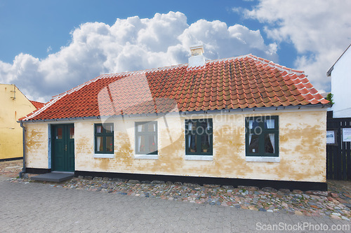 Image of Retro house, home and real estate in countryside with clouds, sky and building on street in Denmark. Vintage architecture, mortgage and Danish residence for lodging, living and old village in Europe