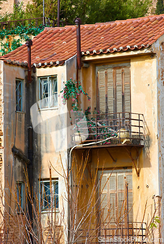 Image of Village, architecture and abandoned house with balcony in Athens for heritage, culture and tradition. Building, property and ancient residential community or neighborhood in ghost town and historic