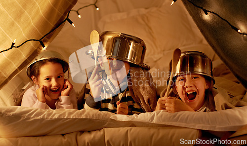 Image of Tent, games and portrait of children at night in bedroom for playing and bonding together. Home, youth and happy kids with spoon, helmet pots and blanket fort for playful, imaginary and childhood fun