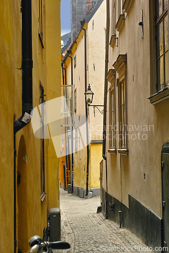 Image of Travel, architecture and alley in ancient town with history, culture or holiday destination in Sweden. Vacation, old buildings and antique stone street in Stockholm with cobble path in vintage city