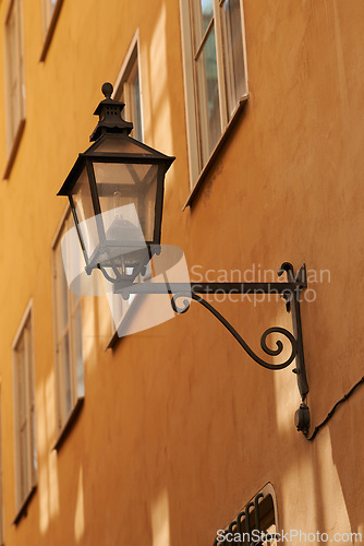 Image of Travel, wall and lantern on vintage building in old town with history, culture or holiday destination in Denmark. Vacation, architecture and antique lamp in Europe with retro light in ancient city