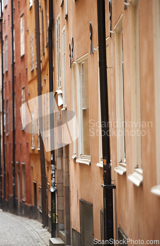 Image of Travel, buildings and alley in vintage town with history, culture or holiday destination in Sweden. Vacation, old architecture and antique street in Stockholm with retro cobble road in ancient city