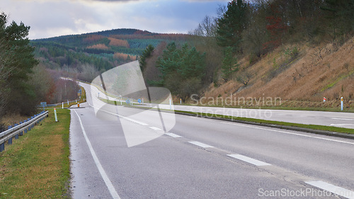 Image of Mountain, road trip and forest landscape for travel, holiday and green scenery with trees in Denmark. Nature, cloudy sky and highway for journey, vacation and outdoor adventure in natural environment