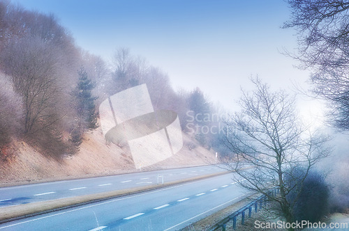 Image of Highway, road trip and natural landscape for travel, holiday and winter trees in countryside. Nature, forest and street for journey, vacation or outdoor adventure with peace, relax and wilderness.