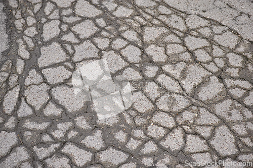 Image of Water, asphalt and road in countryside with cracks for maintenance, infrastructure and transport in winter. Tar, path and rain in erosion pattern on street with damage, ground and problem with travel