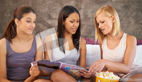 Image of Friends, popcorn and snacks for sleepover, social and bedroom for bonding and reading blog for group. Female people, together and magazines for jokes, besties and entertainment with conversation