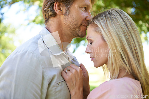 Image of Couple, travel and touch in park for romance, embrace and commitment in marriage or relationship. Mature people, love and bonding on outdoor date in garden, support and trust on summer holiday