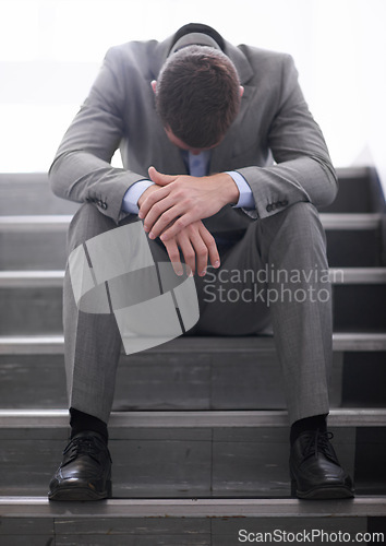 Image of Businessman, failure or job loss in company or sad, rejection or thinking of career crisis. Salesman, sad and mental health on staircase for fired, worry and depression for termination of contract