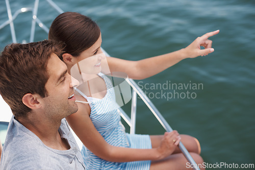 Image of Happy couple, boat and romantic cruise for honeymoon, pointing and looking at ocean horizon. Smile, yacht and luxury on the water transportation, holiday and travel in Bora Bora for tourism