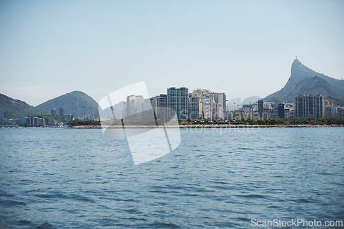 Image of Ocean, city and seascape with mountain, sky and buildings on cityscape, water and outdoor in urban Cape Town. Landscape, sea and coast in blue skyline, beach and summer for travel, nature and view