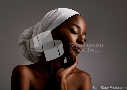 Image of Beauty, cosmetics and black woman in dark studio with head scarf, skincare and pride in culture. Relax, skin glow and face of African model with dermatology, turban and girl on grey background