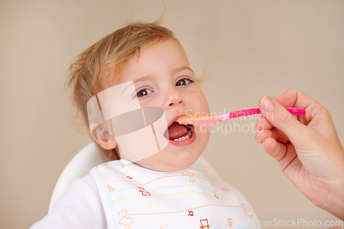 Image of Spoon, baby girl and chair for eating food for nutrition, growth and development. Young child, happy and excited for feeding breakfast or meal and snack for wellbeing or hungry in morning or home