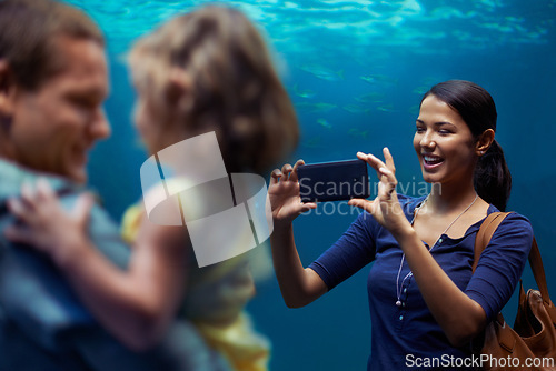 Image of Aquarium, woman or phone for photo, family or outing for fun, happy or bonding together in Brazil. People, smartphone and fish tank for social media, exploration and marine life on playful weekend