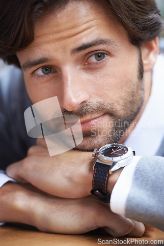 Image of Man, fashion and watch for thought, thinking and handsome in beard, jersey and lean on table in closeup. Businessman, formal and vision for salesman, idea and professional job with serious look