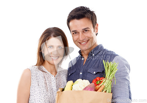 Image of Happy couple, portrait and shopping bag with groceries for food, natural sustainability or nutrition on a white studio background. Young man and woman with smile for healthy vegetables or ingredients