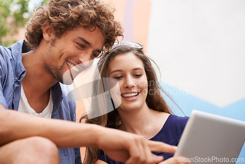 Image of Happy students, together and studying with tablet connectivity, teamwork and education in university. Young people, man and woman work with technology in collaboration, concentrate and sit on campus