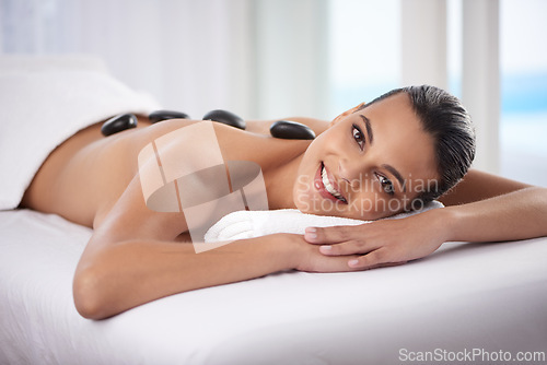 Image of Portrait, hot stone and woman with massage at spa for wellness, health and back treatment. Self care, cosmetic and young female person sleeping for warm stone back therapy at natural beauty salon.