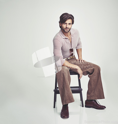 Image of Man, vintage and clothes for fashion, studio and handsome with retro aesthetic, handsome and portrait. Male person, chair and backdrop or background and model with sunglasses, luxury and funky