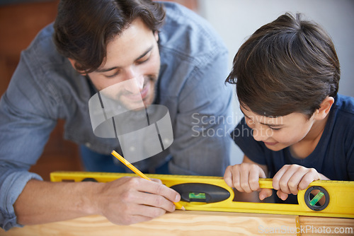 Image of Dad, kid and woodwork pencil for project, bonding and building with safety gear. Father, son and carpenter for renovating, measuring and teaching moment for development of house with spirit level