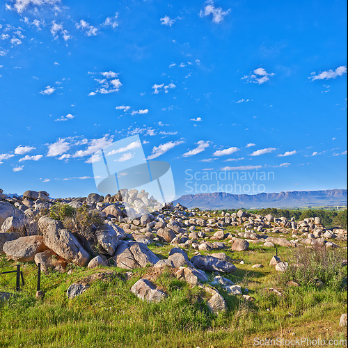 Image of Mountains, rocks and clouds in blue sky for travel, hiking and eco friendly tourism or explore with beautiful view. Background of landscape, environment and field in summer by countryside with mockup