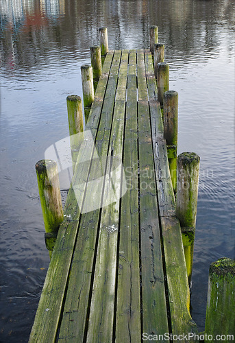 Image of Wood, bridge and lake in nature for travel, environment and camp destination for summer. Wooden pier, dock or path to water, peace and calm in location for adventure with perspective and background