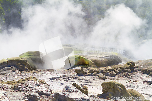 Image of Rocks, smoke or vapor in nature with landscape, sulphuric pool or volcano in environment. Steam, mist and fog with heat from natural hot spring, Earth and stone with mountain for travel or tourism
