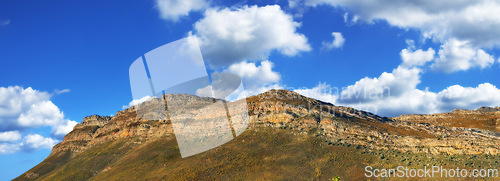 Image of Mountain, landscape and blue sky with clouds in heaven or countryside in Africa at summer. Morning, outdoor and banner of hill on horizon with aerial view of bush environment with grass on stone