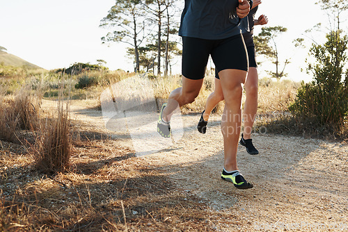 Image of Closeup, people and legs with running for fitness, exercise or outdoor training on dirt road. Person and runner with sports shoes or footwear for hiking, trekking or cardio workout together in nature