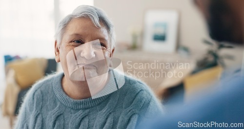 Image of Communication, portrait and senior woman with nurse for conversation, talking or chat in house. Happy, relax and elderly person in living room of home speaking to friend or caregiver for healthcare