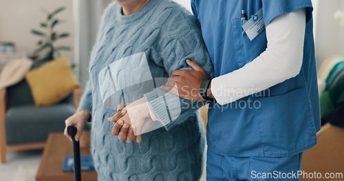 Image of Nurse, senior person and holding hands with walking stick for support at retirement home. Elderly patient with a disability, caregiver or cane in rehabilitation for health, physical therapy or help