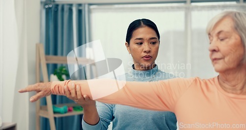 Image of Physiotherapy, stretching and senior patient in consultation for support, exam and helping with shoulder in office. Doctor, physiotherapist or nurse with elderly woman for muscle massage or service