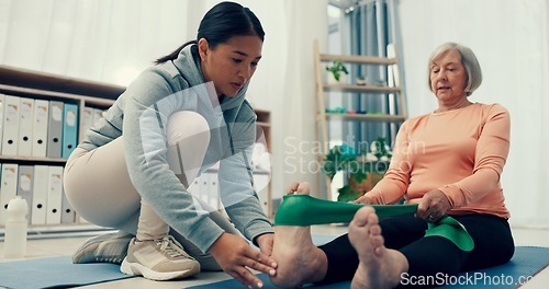 Image of Senior care, stretching band or physiotherapist with old woman, legs or healthcare for nursing. Physio, rehabilitation or elderly patient with fitness coach, caregiver and injury in mobility training