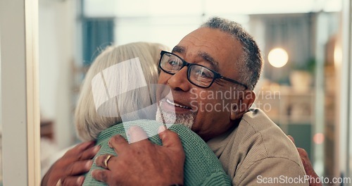 Image of Love, hug and senior couple in home, together and support, trust or care during retirement. Diversity, smile and happy with elderly man, woman and embracing for romance in their house for wellness