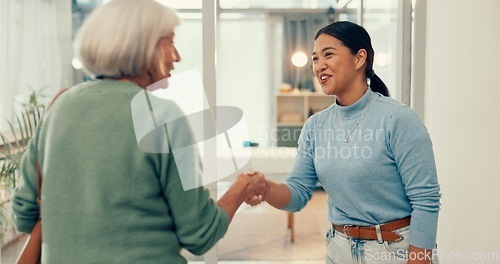 Image of Happy woman, physiotherapist and handshake in elderly care, appointment and meeting at hospital clinic. Female person, medical and healthcare professional shaking hands with senior patient in checkup