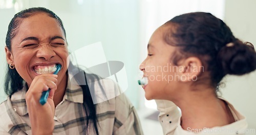 Image of Happy, brushing teeth and mother with daughter, wellness and child development in bathroom. Smile, family or mama with kid and healthy with morning routine or toothbrush with fresh breath or dental