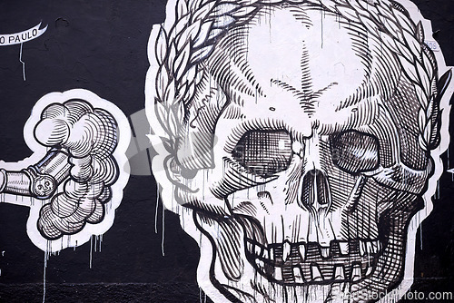 Image of Graffiti, painting and wall mural in neighborhood with skull illustration and creativity in the city. Urban, art and black and white on a street with drawing in Sao Paulo outdoor with design tag