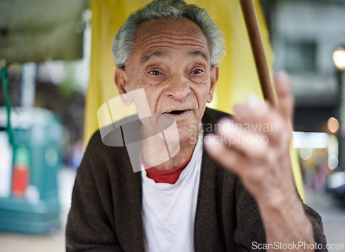 Image of Conversation, city and senior man talking in a neighborhood outdoor with chat and communication. Urban, sitting and Asian male person with wisdom, street and road with travel and advice with gesture