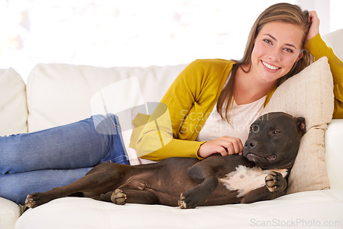 Image of Woman, dog and relax on couch in portrait, smile for pet love and bonding at home with domestic canine. Happy, positive and trust with foster or adoption, stroke puppy in living room and animal care