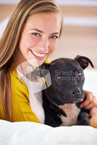 Image of Woman, dog and happy in living room in portrait, smile for pet love and bonding at home with domestic canine. Relax, positive and trust with foster or adoption, pitbull puppy and animal care on couch