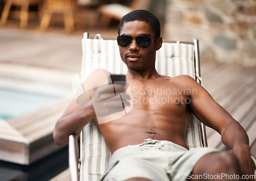 Image of Happy man, browse and relax on deckchair, phone and scroll on social media on summer holiday. Black male person, smile and online for blog or app for chat on travel to Nigeria, vacation and outdoors