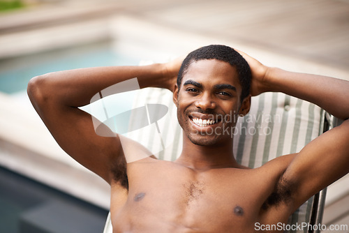 Image of Man, portrait and relax by pool on chair, happy and swimming on weekend for fun on summer holiday. Black male person, smile and calm or peace on travel to Nigeria, vacation and outdoors for leisure