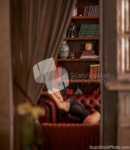 Image of Woman, thinking and couch with lingerie and door of a study with sensual clothing and underwear. Home, relax and nap with library, sleep and female person with leather sofa in a house with style