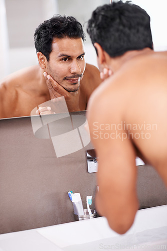 Image of Skincare, wellness and mirror with man in bathroom for grooming, cleaning and morning routine. Reflection, hygiene and face of male person for self care, dermatology and facial treatment in washroom.