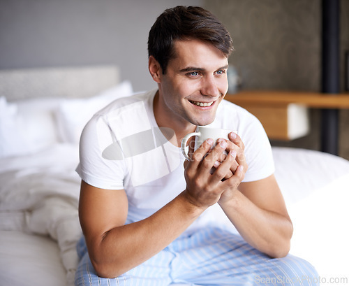 Image of Man, bedroom and morning coffee sitting and thinking, weekend off in apartment to relax with attractive male person. Casual and holiday or home, Saturday off day and comfortable positive guy with cup
