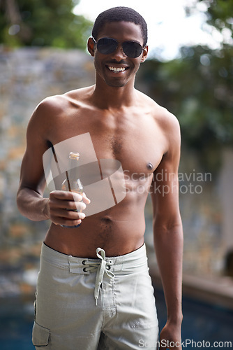 Image of Man, sunglasses and shirtless with beer in summer for relax, celebration and weekend drinks by swimming pool. African person, face and topless with smile, alcohol or holiday fun on vacation at resort