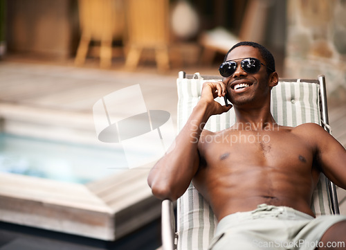 Image of Man, happy and relax on deckchair, phone call and communication on summer holiday. Black male person, smile and voip for conversation, app and networking on travel to Nigeria, vacation and outdoors