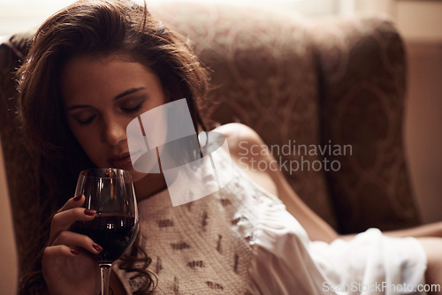 Image of Woman, couch and wine to relax at home, alcohol and natural ambient light with eyes closed. Smelling, aroma with liquid in glass, comfortable at house after meal in free time on weekend holiday