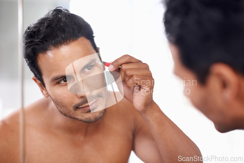 Image of Eyebrow, hair removal and tweezers of man for maintenance, grooming and self care in bathroom mirror. Cosmetology, skincare and male person for facial treatment, brows shape and morning routine.
