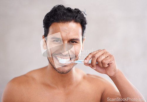 Image of Oral hygiene, portrait and man in bathroom for brushing teeth, self care and morning routine. Dental, smile and face of Mexican male person at home for wellness, toothbrush and healthy mouth.