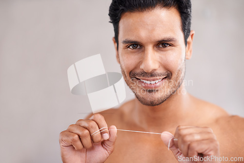 Image of Dental, portrait and man in bathroom for flossing teeth, self care and morning routine. Oral hygiene, confidence and face of Mexican male person at home for wellness, cleaning and healthy mouth.